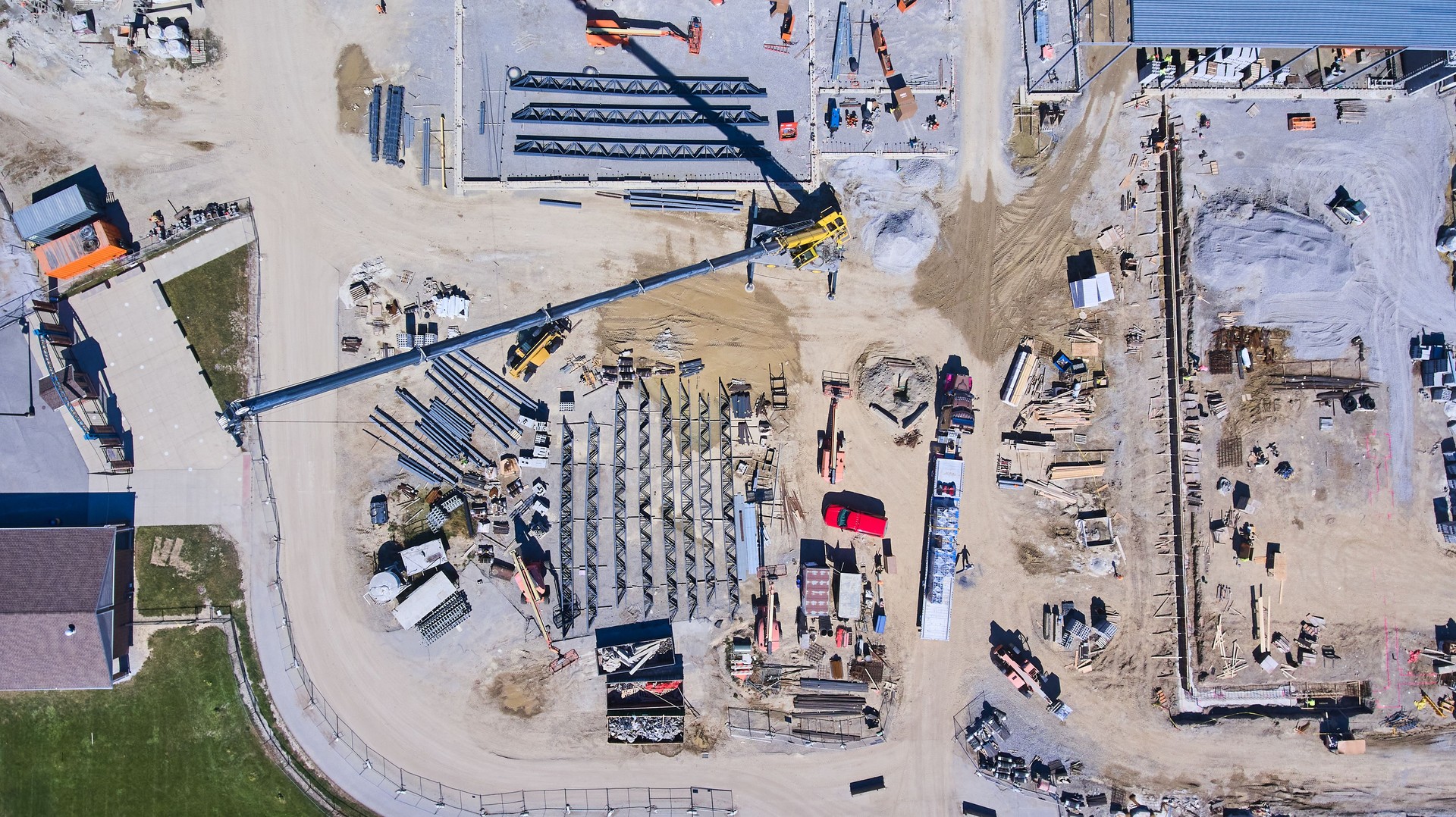 Aerial of large construction site with equipment and workers